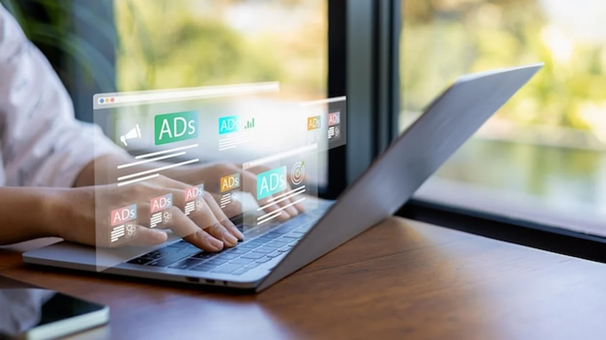 Kobieta korzystająca z laptopa i tabletu z dashboardem reklam